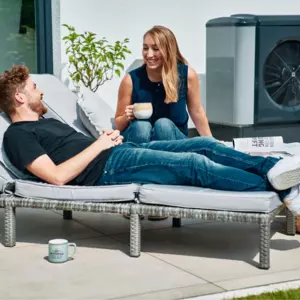 Zwei Menschen im Garten mit Wärmepumpe